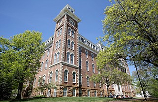 University of Arkansas students are shown on the lawn in front of Old Main on the campus in Fayetteville in this file photo.